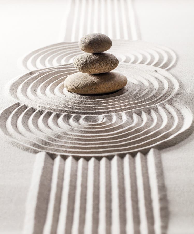 Three zen pebbles and 3 circles designed in sand for meditation and relaxation. Three zen pebbles and 3 circles designed in sand for meditation and relaxation