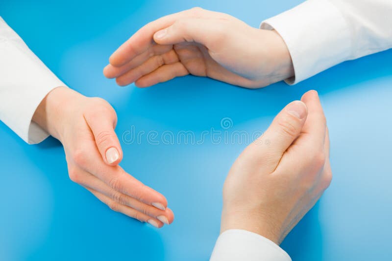Human hands making symbolic circle on a blue background. Symbolic stock images, royalty-free photos and pictures