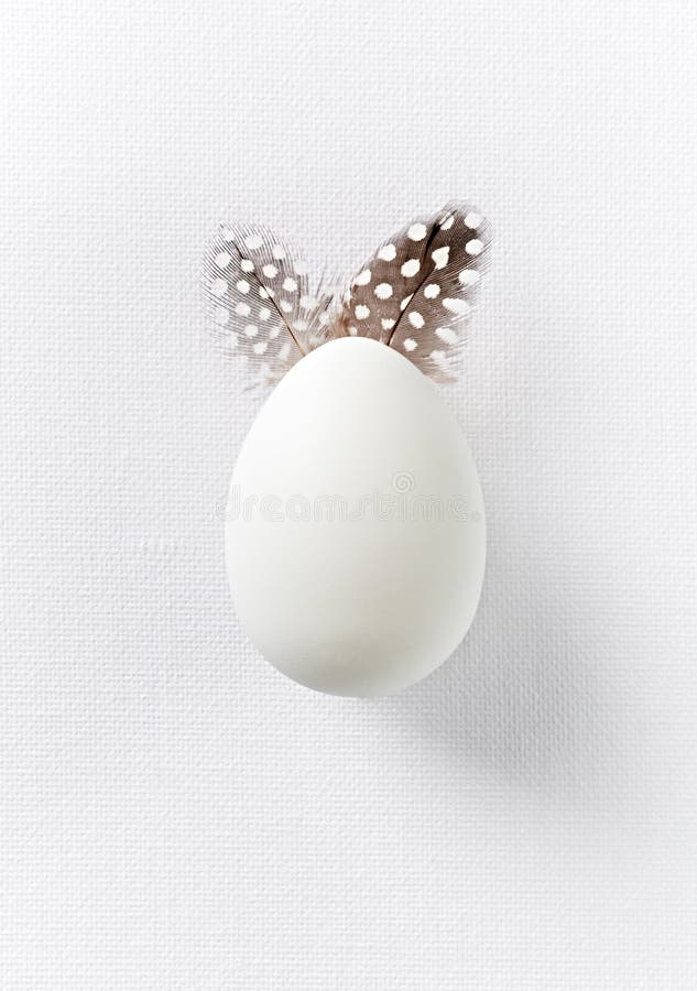 Symbolic Easter Bunny made with White Egg and Feathers. Top view. Copy space. Symbolic stock images, royalty-free photos and pictures