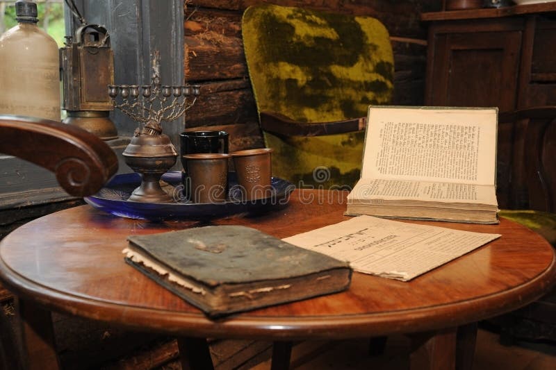 The symbols of the Jewish people lie on an old wooden table. Menorah and old books