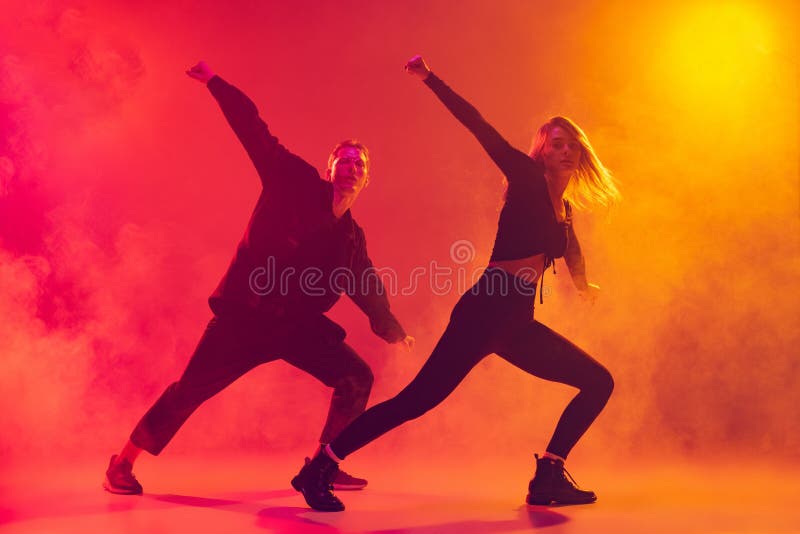 Bottom View of Two Young Hip-hop Dancers in Motion Isolated Over Gradient  Pink Yellow Background in Neon Light in Smoke Stock Image - Image of young,  nightclub: 230719141