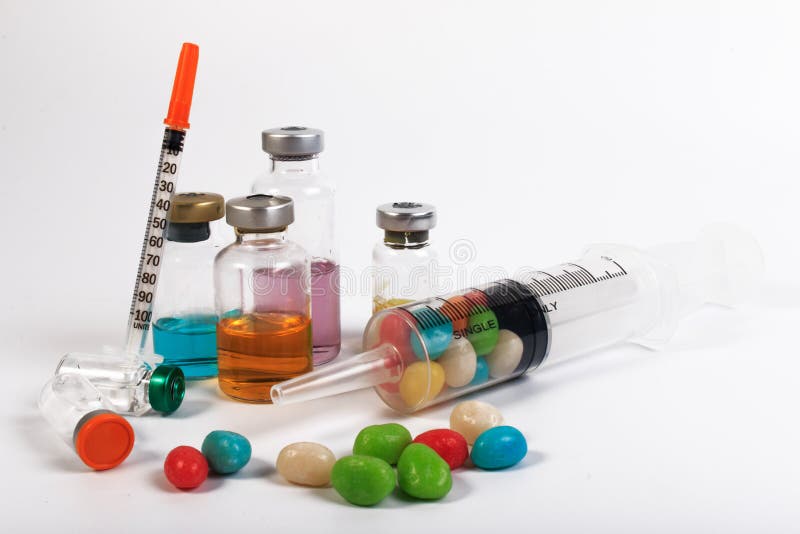 A Syringe and Candy Bottle. Stock Photo Image of large, injection