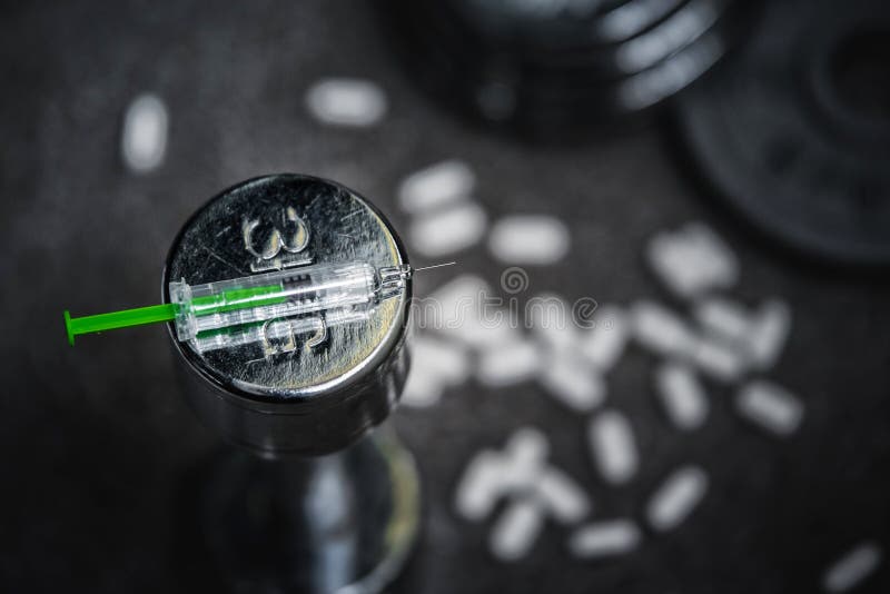 Syringe and drugs in gym, doping in sport concept photo