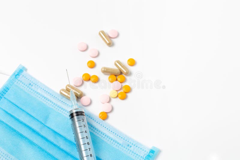 Syringe with drugs and hygienic mask on white background, equipment medical concept. Syringe with drugs and hygienic mask on white background, equipment medical concept