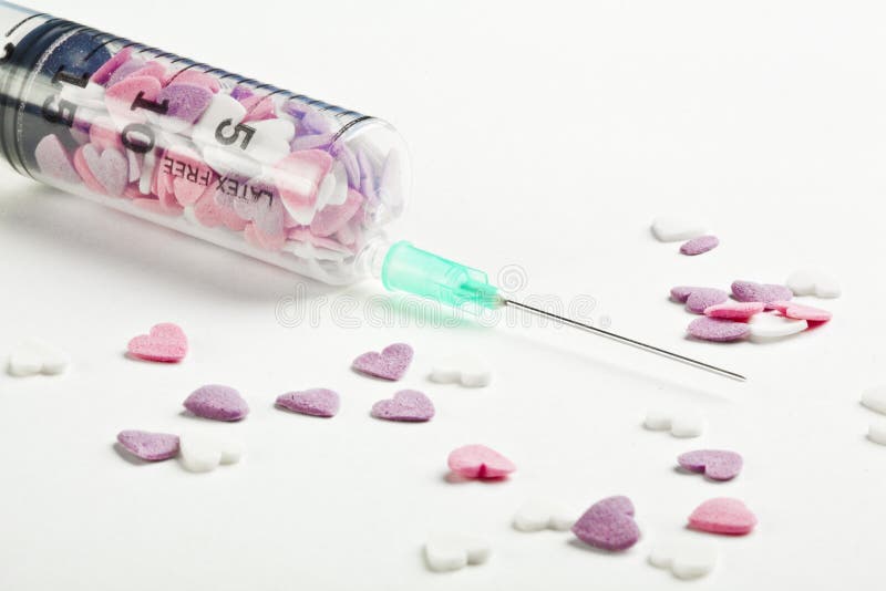 Syringe filled with heart shaped candy