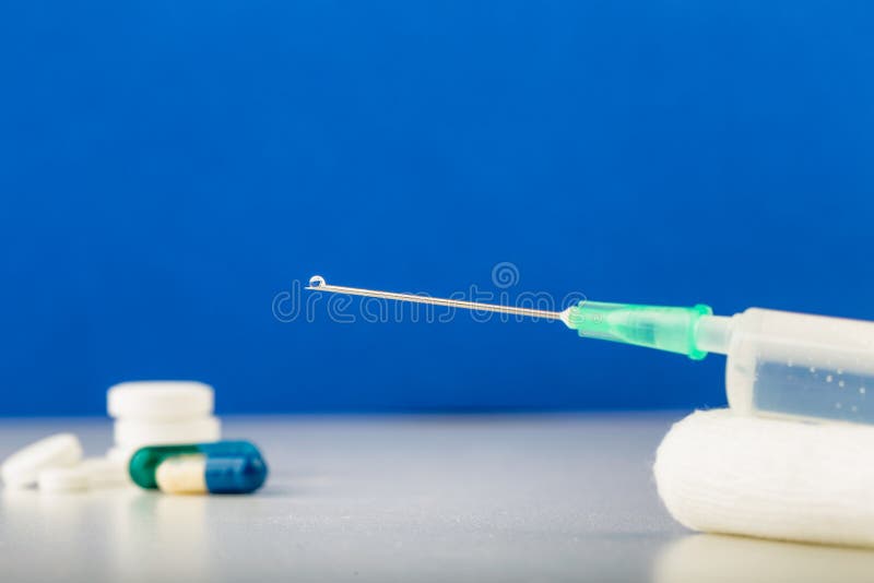 Syringe on Gauze with Drop on Top of Needle. Medical Tools Stock Photo