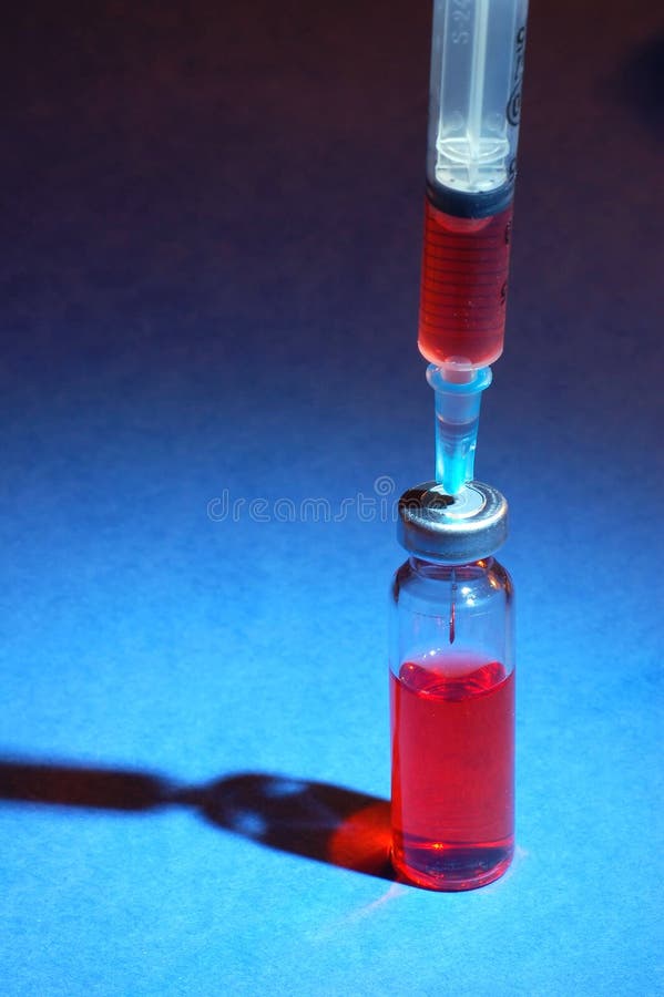 Syringe and glass vial stock photos
