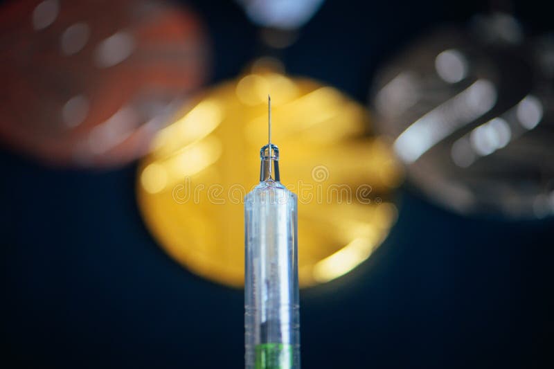 Syringe and medal set in background. Doping and drugs in sport, concept photo. Black background. High Quality Photo. Natural Light