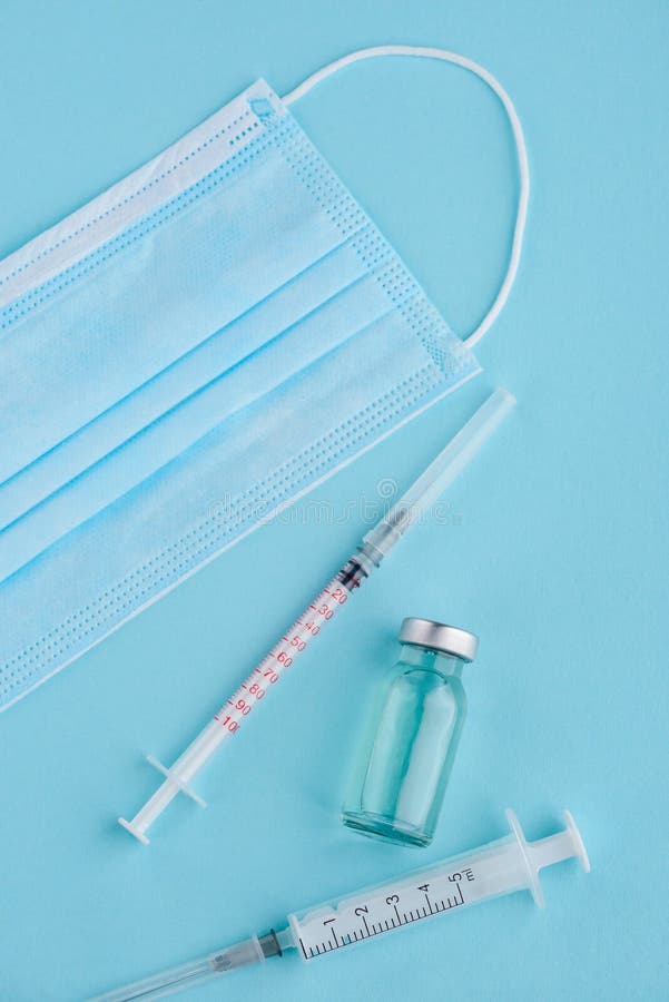 Syringes, vial and doctor`s mask stock image Syringes, vial and doctor`s mask stock image