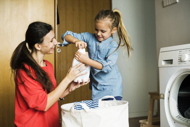 Kid helping house chores with mother. Kid helping house chores with mother