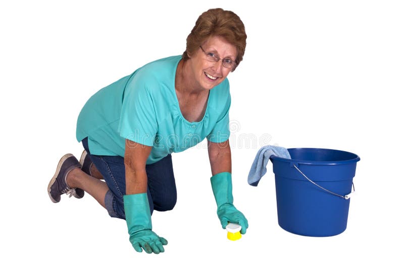 Mature senior woman on hands and knees washing and scrubbing the floor and ready to do spring cleaning and household chores. She is smiling as she cleans her house. Isolated on white. Mature senior woman on hands and knees washing and scrubbing the floor and ready to do spring cleaning and household chores. She is smiling as she cleans her house. Isolated on white.