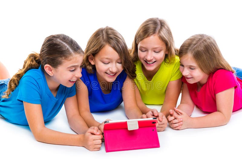 Sisters cousins kid girls with tech tablet pc playing happy lying on white background. Sisters cousins kid girls with tech tablet pc playing happy lying on white background