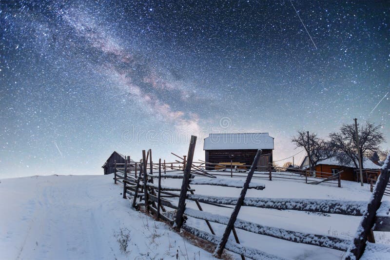 Chalets in the mountains at night under the stars. Magic event in frosty day. In anticipation of the holiday. Dramatic scenes. Carpathians, Ukraine, Europe. Chalets in the mountains at night under the stars. Magic event in frosty day. In anticipation of the holiday. Dramatic scenes. Carpathians, Ukraine, Europe