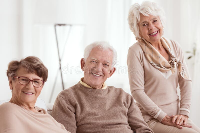 Happy group of seniors smiling, light background. Happy group of seniors smiling, light background