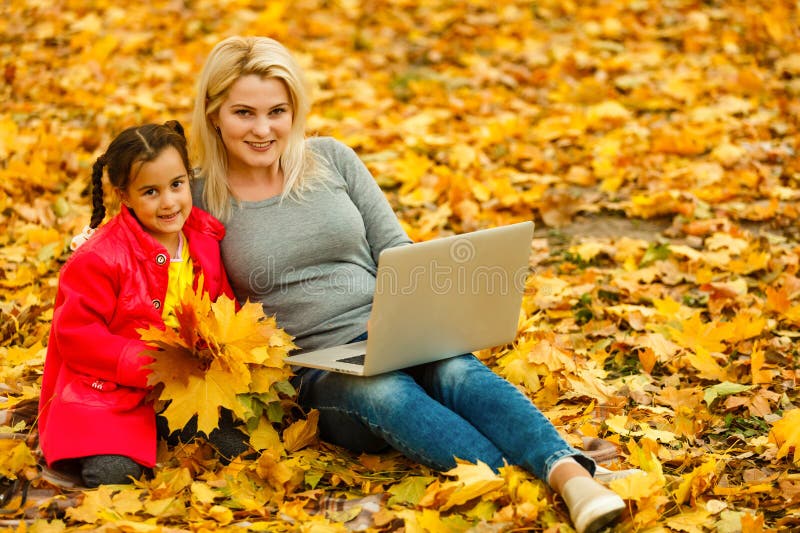 Happy mother and her tdaughter using. Happy mother and her tdaughter using