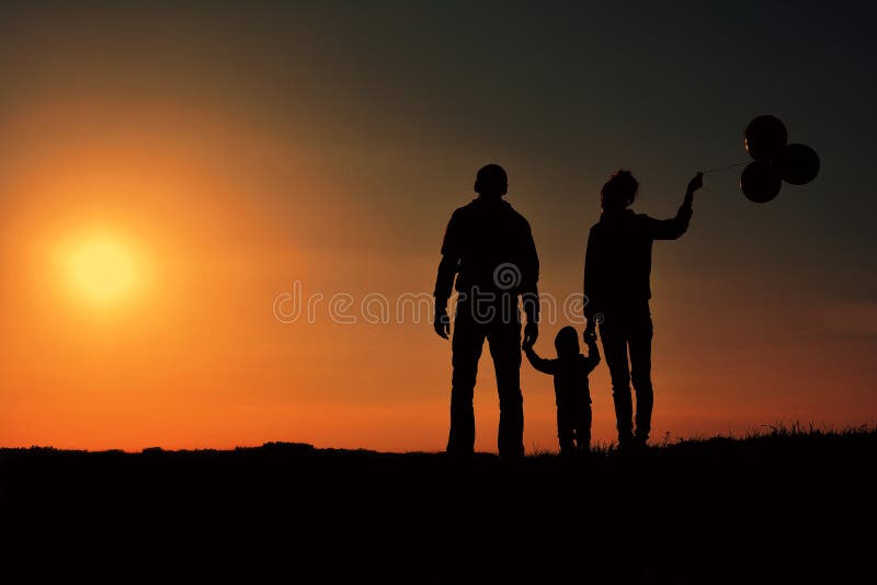 Family with balloons silhouette on a hill in the sunset, Czech Republic. Family with balloons silhouette on a hill in the sunset, Czech Republic