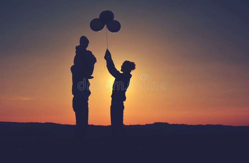 Family with balloons silhouette on a hill in the sunset, Czech Republic. Family with balloons silhouette on a hill in the sunset, Czech Republic