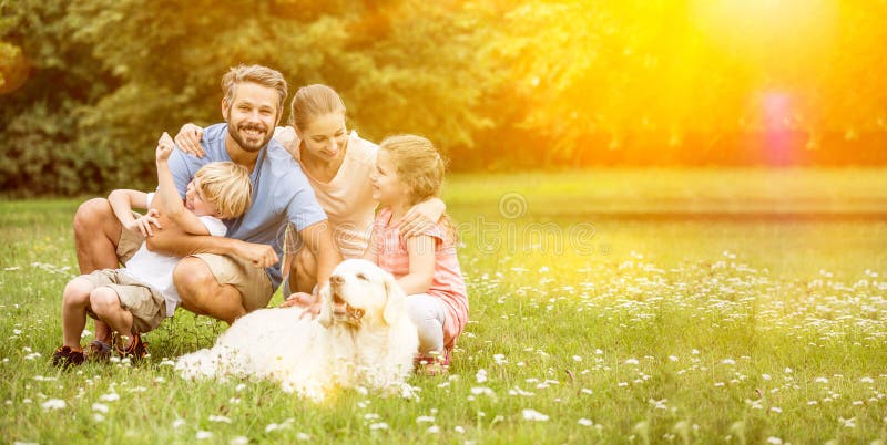 Happy family with children and dog together in the garden in summer. Happy family with children and dog together in the garden in summer