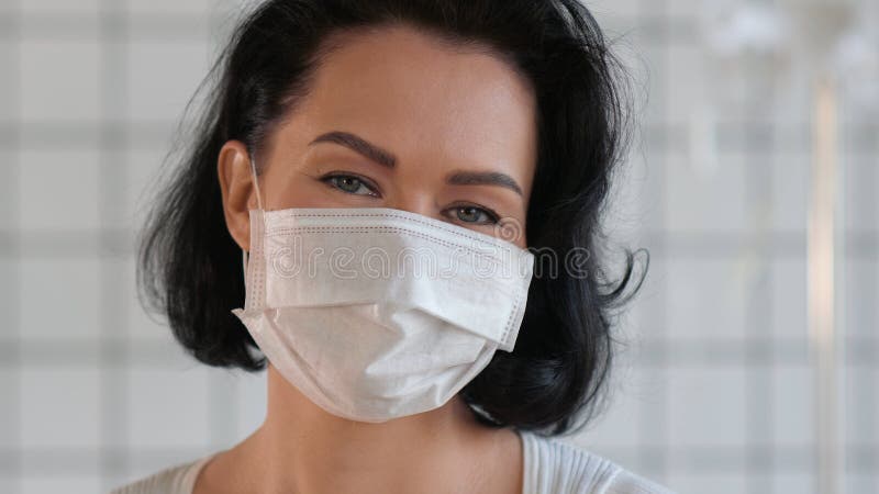 Szczęśliwa uśmiechnięta samica nosząca maskę ochronną. fotografia stock