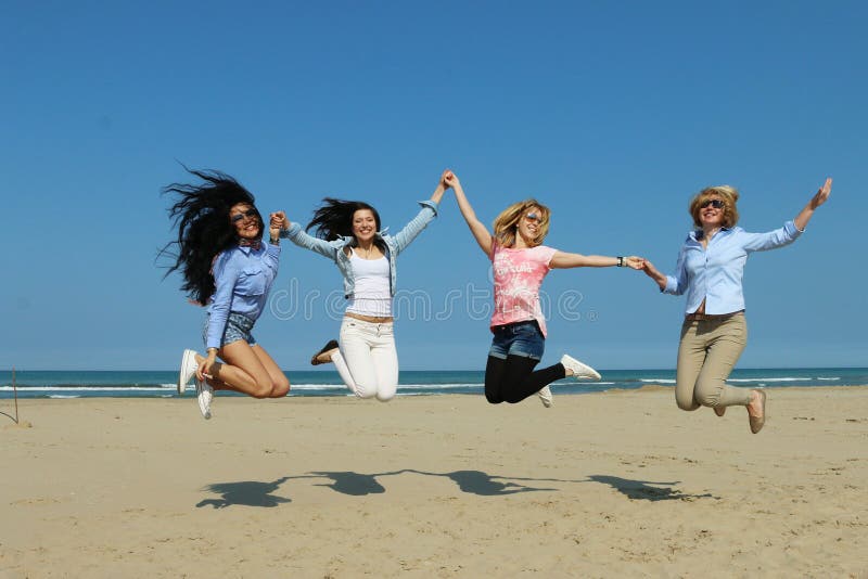 Best friends, 4 happy joyful girl friends from multi racial backgrounds jump on beach with joy and happiness. Best friends, 4 happy joyful girl friends from multi racial backgrounds jump on beach with joy and happiness