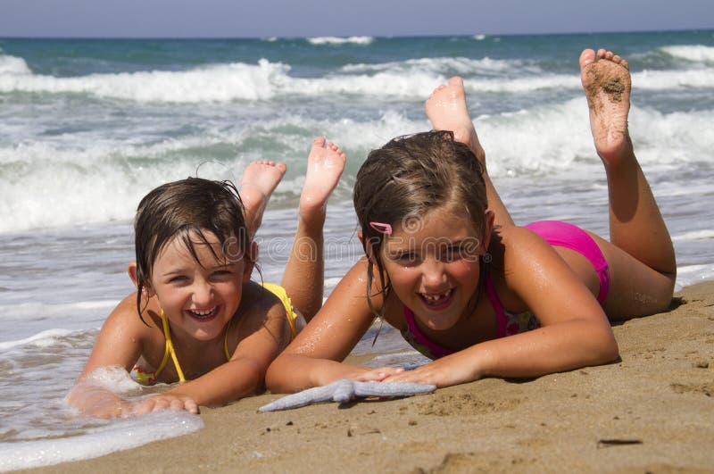 Happy girls on the beach with starfish. Happy girls on the beach with starfish