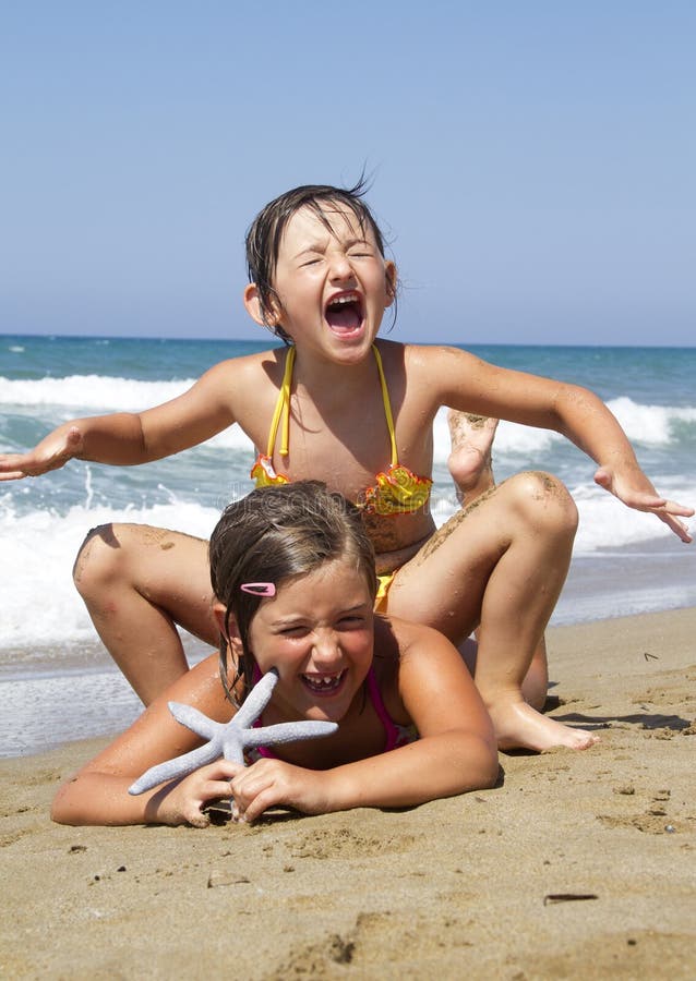 Happy girls on the beach with starfish. Happy girls on the beach with starfish