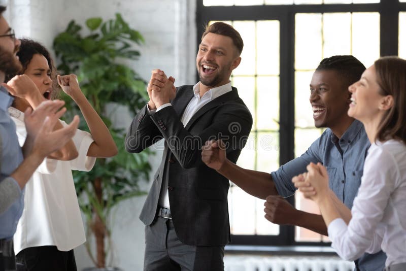 Happy businessman with team celebrate corporate victory together in office. Diverse overjoyed professional group rejoice company victory. Teamwork success win triumph concept at conference table. Happy businessman with team celebrate corporate victory together in office. Diverse overjoyed professional group rejoice company victory. Teamwork success win triumph concept at conference table.