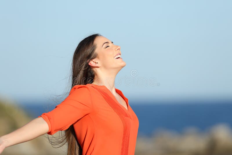 Szczęśliwy kobiety oddychania świeże powietrze w wybrzeżu