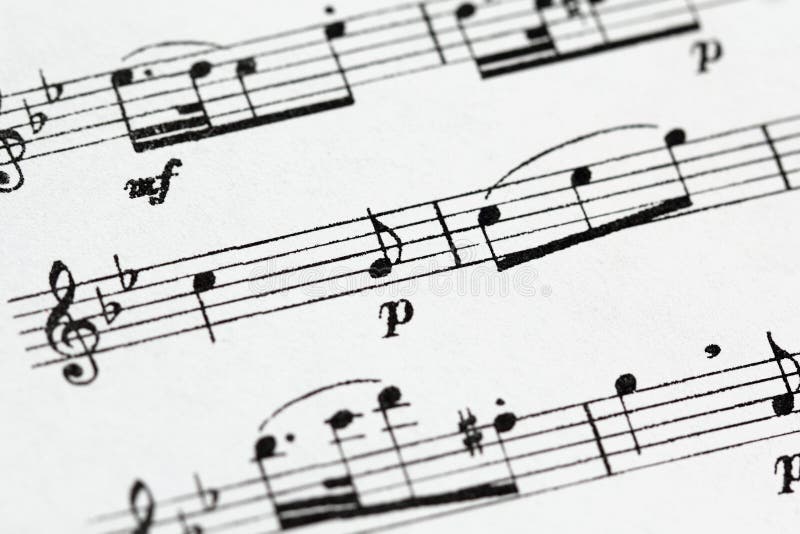 Macro of sheet music with treble clef, notes and with a designation volume p (piano) - quiet and mf (mezzo-forte) - moderately loud. Macro of sheet music with treble clef, notes and with a designation volume p (piano) - quiet and mf (mezzo-forte) - moderately loud.