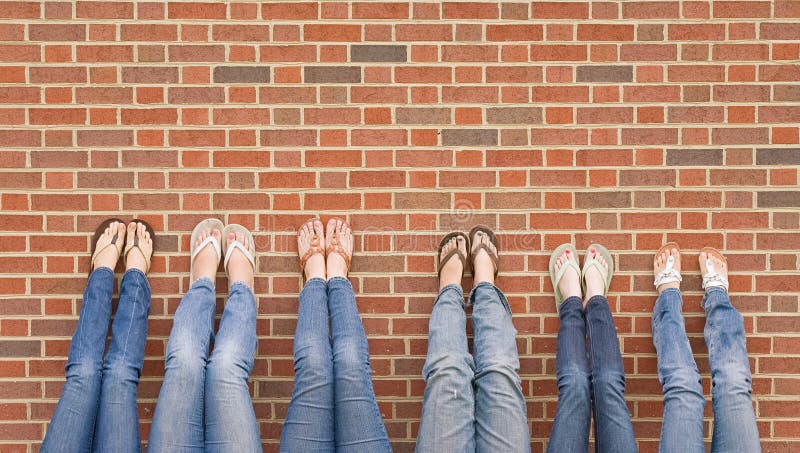 Group of College Girls at School With Legs up on Wall. Group of College Girls at School With Legs up on Wall