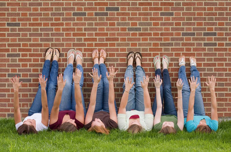 Group of College Girls at School With Legs up on Wall. Group of College Girls at School With Legs up on Wall