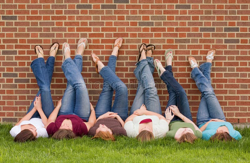 Group of College Girls at School With Legs up on Wall. Group of College Girls at School With Legs up on Wall