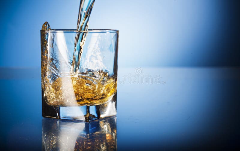 Glass of whisky in dark background. Glass of whisky in dark background