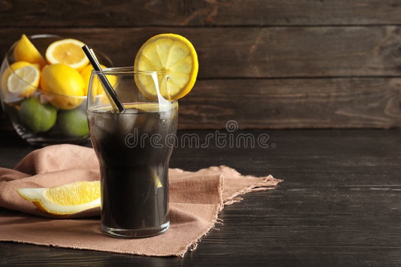 Glass with natural black lemonade on table. Glass with natural black lemonade on table