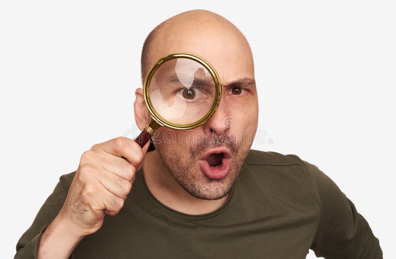 Szokujący łysy facet patrzeje przez powiększać - szkło obraz stock Szokujący łysy facet patrzeje przez powiększać - szkło obraz stock