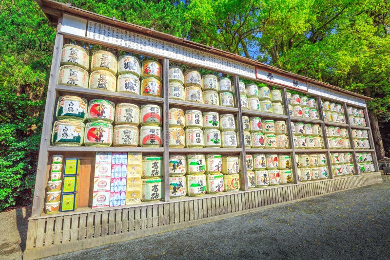 Kamakura, Japan - April 23, 2017: Japanese sake rice wine barrels with decorative writing in Tsurugaoka Hachiman, the most important Shinto shrine in Kamakura.Sake is an alcoholic beverage of Japanese. Kamakura, Japan - April 23, 2017: Japanese sake rice wine barrels with decorative writing in Tsurugaoka Hachiman, the most important Shinto shrine in Kamakura.Sake is an alcoholic beverage of Japanese