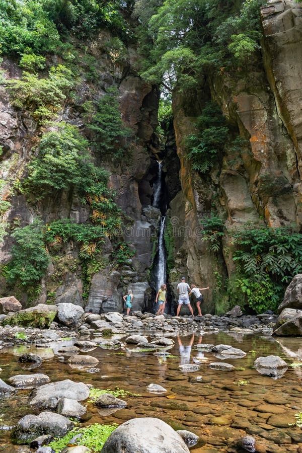 SÃ£o Miguel, Azores PORTUGAL - 6 August 2020 - Family of four by the waterfall of Salto do Cabrito