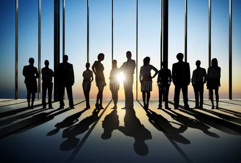 Confident silhouette of business people posing for the camera indoors. Confident silhouette of business people posing for the camera indoors.