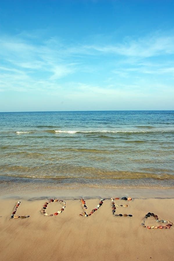 Word LOVE on beach sand, made from rocks. Word LOVE on beach sand, made from rocks