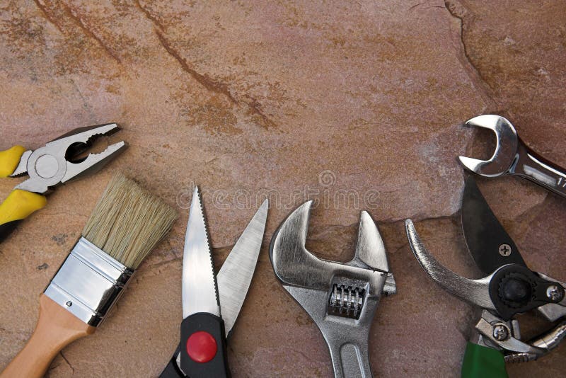 Selection of tools on a stone background. Selection of tools on a stone background