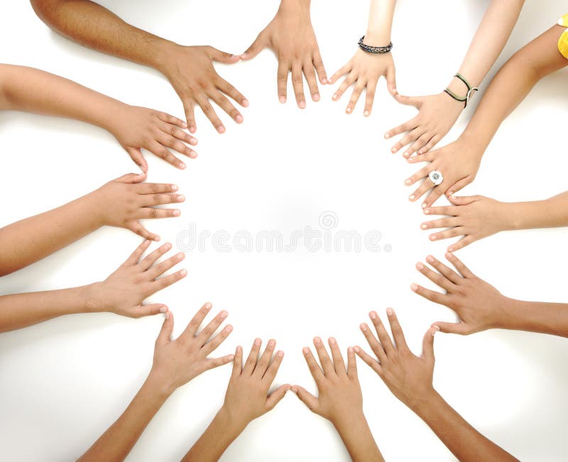 Conceptual symbol of multiracial children hands making a circle on white background with a copy space in the middle. Conceptual symbol of multiracial children hands making a circle on white background with a copy space in the middle