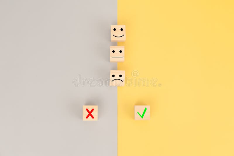 Emotion symbol with false and correct symbol on cube wooden block. Emotion symbol with false and correct symbol on cube wooden block