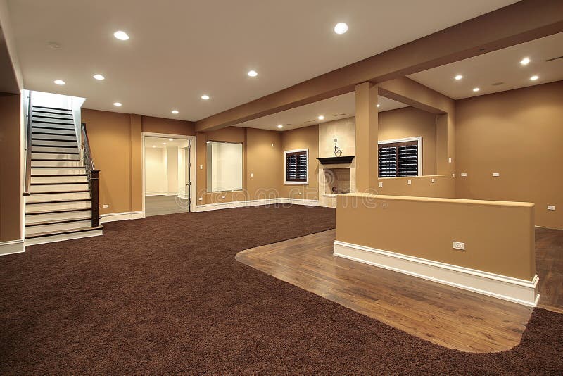 Lower level basement in earth tones and marble fireplace. Lower level basement in earth tones and marble fireplace