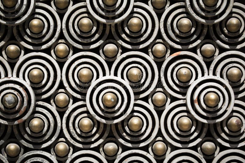 Close up view of an iron circles pattern of an old vintage door. Close up view of an iron circles pattern of an old vintage door.