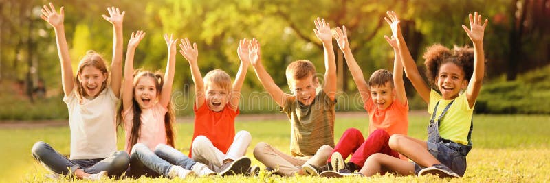 Cute little children sitting on grass outdoors on sunny day. Banner design. Cute little children sitting on grass outdoors on sunny day. Banner design