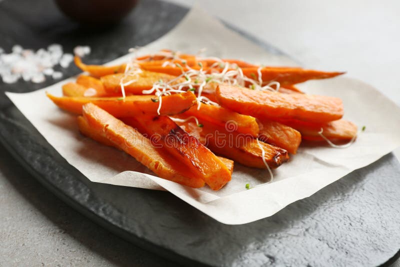 Sweet potato fries on slate board, closeup. Sweet potato fries on slate board, closeup