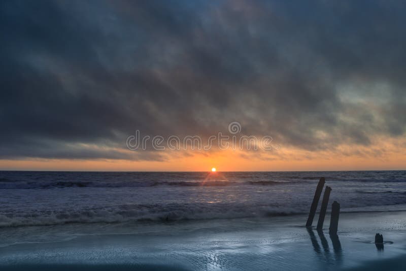 Sunset over the Pacific Ocean and an old pier in Fort Funston, San Francisco, California, USA. Sunset over the Pacific Ocean and an old pier in Fort Funston, San Francisco, California, USA.