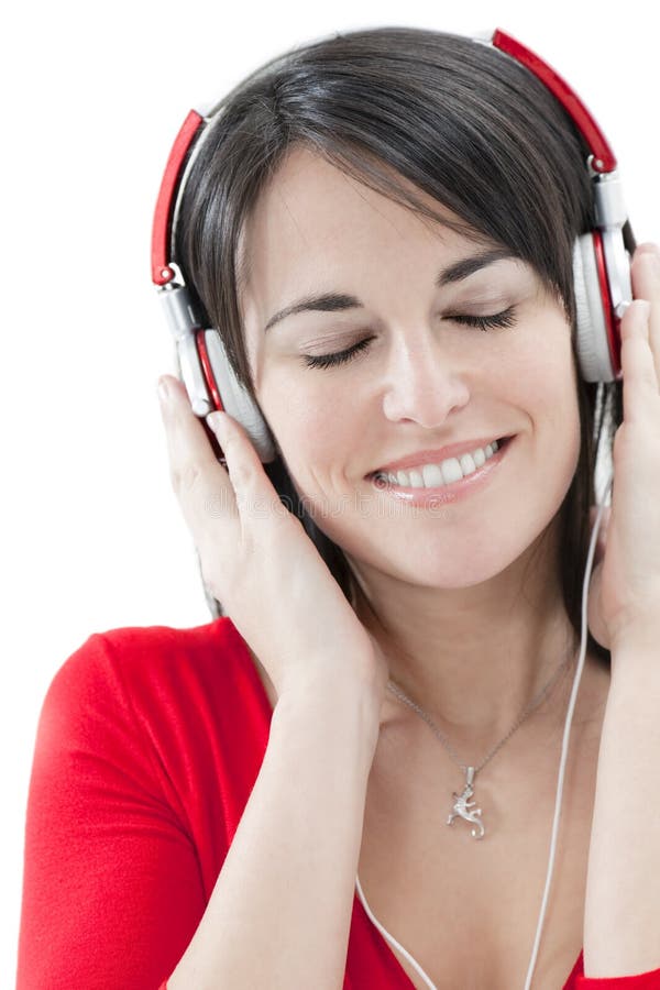 Mid adult woman listening to music on white background. Mid adult woman listening to music on white background.