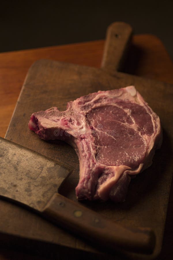 Tbone Roast Beef Steak with a Vintage Cleaver on a Cutting Boar Stock