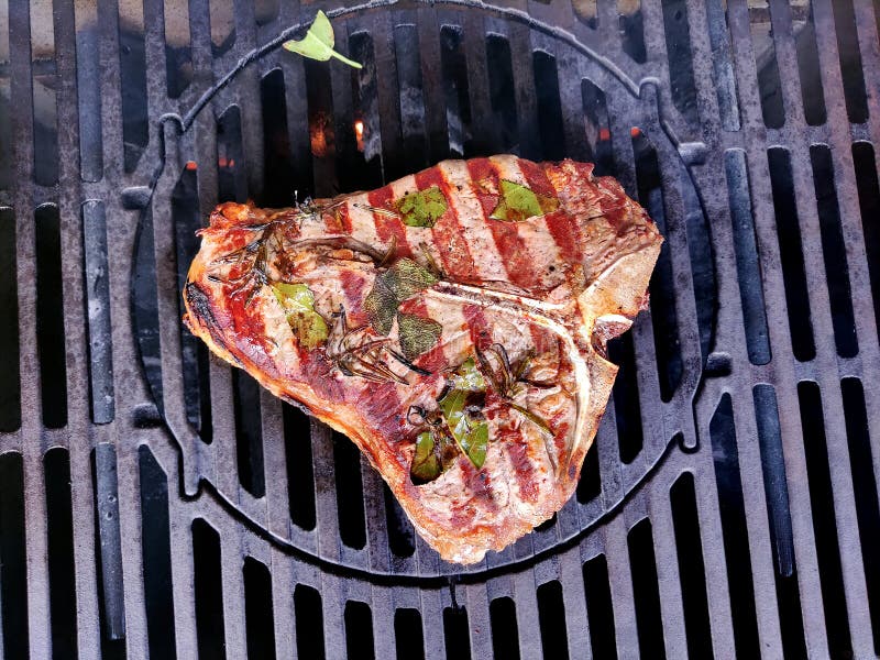 Tbone Steak Flavored with Herbs Cooks on the Grill Stock Image Image